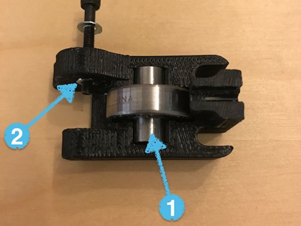 Slide the idler assembly out of the extruder assembly, and remove the idler bearing (1) and nut (2) from the 3D printed structure.