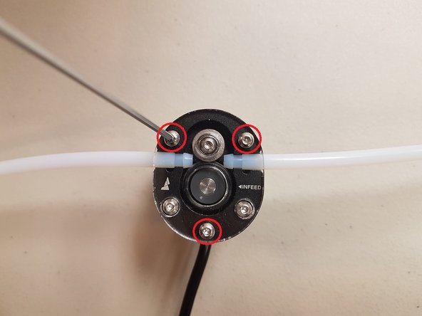 If you are using a Bowden printer, you will need to make a slight adjustment to your Scroll Wheel.  First, unscrew the top three screws fastening the acrylic plate.