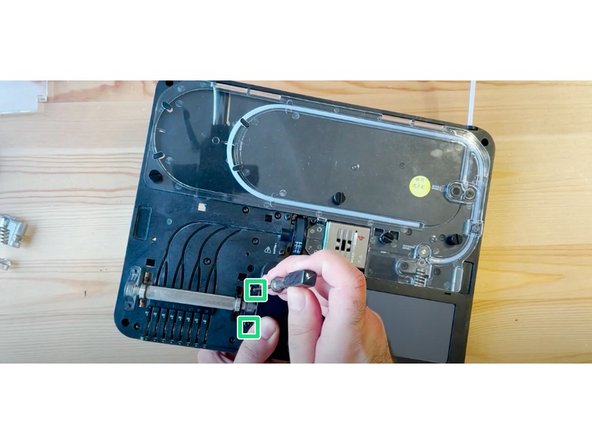 Flip the unit over while supporting both the CAM and ingoing drive, and replace 2 of the front screws to secure the end cap.