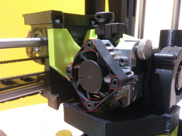 Turn off the printer. Remove 4 screws from the square fan. Gently pull the fan back and allow it to hang from the side. Place the 4 screws in a safe spot as they will be needed for reinstallation shortly.