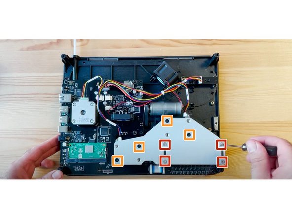 Flip substructure so that the screen is on the bottom, and the electronics are facing up. Using the torx screwdriver provided, undo CAM bracket screws.