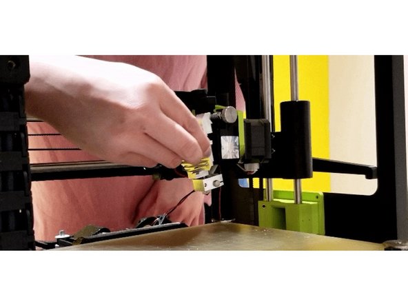 Gently separate the heat sink from the motor assembly. Remove the heat sink slowly and cautiously as the idler spring may fall out.