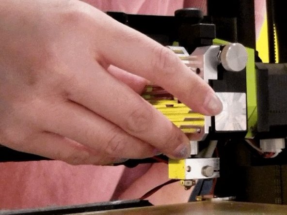 Reinstall the heat sink. Secure the upper left screw first with the red wire. We found that it is easier to attach the red wire to this screw then to the bottom right screw where it originally was. You can choose to do either.