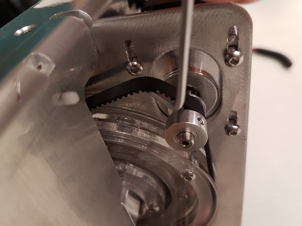 Once the belt is back in place, replace the nut and bolt to secure the T-tab onto the cutter wheel.  