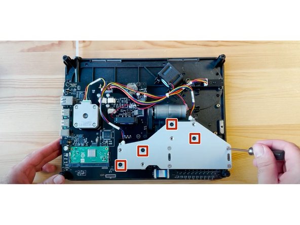 Flip the unit back to face the bottom. Reassemble bracket, putting black screws back on diagonals half tightened.