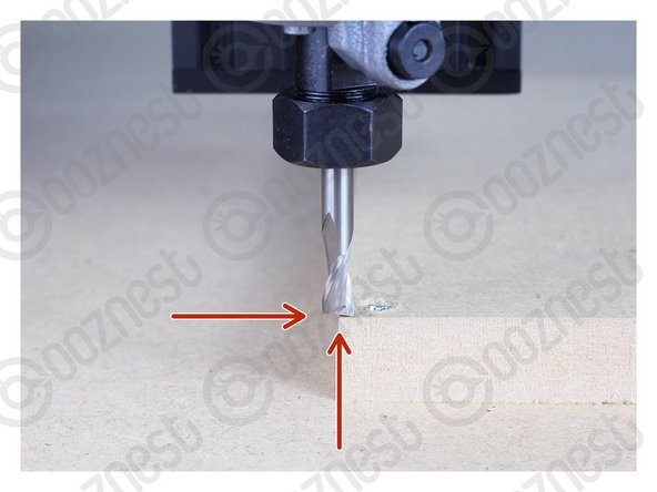 The tip of the end mill should be flush with the top of the MDF.