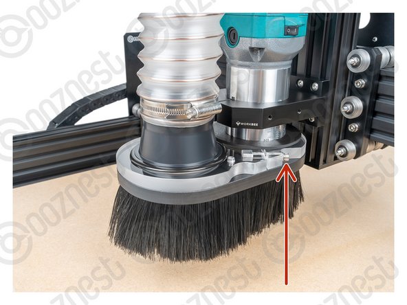 Adjust the height of the Dust Shoe so the tip of the brushes are just touching the MDF piece we are cutting.