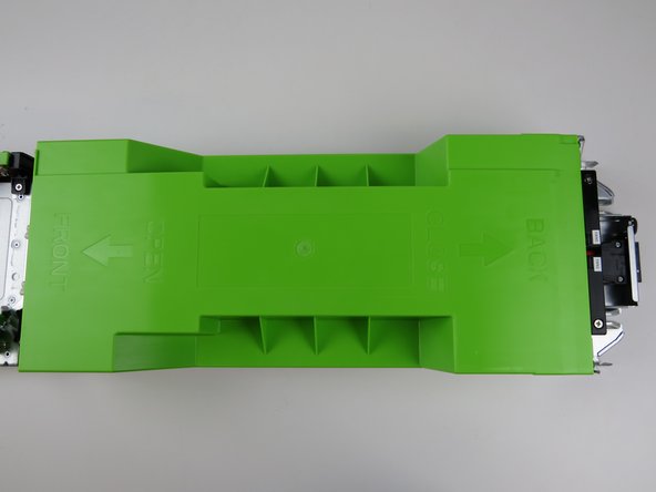 Grab the center portion of the chassis lid as shown.