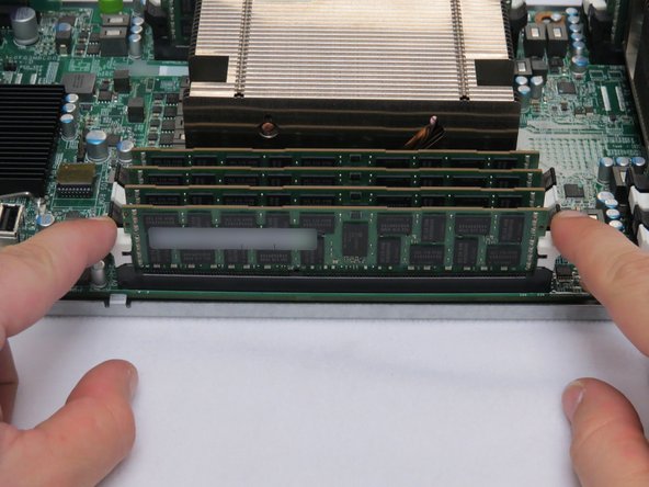 Press down on the (2) retention tabs.