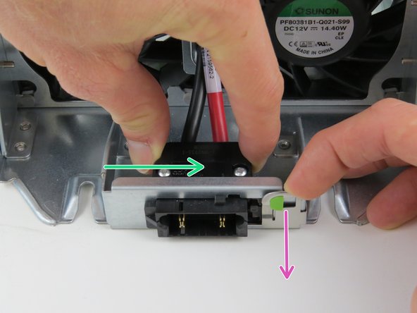 Engage the metal retention tab on the slide-to-lock panel to release the side-plane power connector.