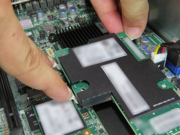 Gently push the rear corners of the NIC upwards.