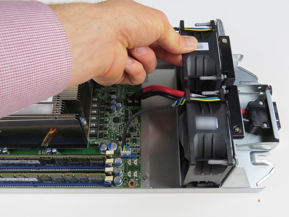 Carefully grab the failed fan and lift upwards to remove from the housing.