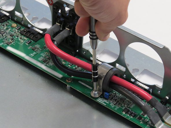 Unscrew one Phillips #2 screw securing the bus lead management clip to the fan controller board.