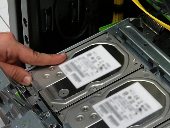 Push each hard disk drive away from the pivot point of each gate.