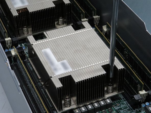 Continue to unscrew the screws holding the heat sink to the CPU until you can remove it.