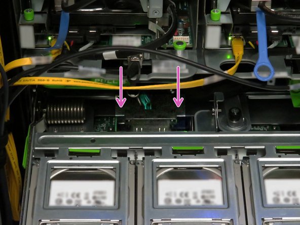 Press the two Powerblade cable retention tabs.