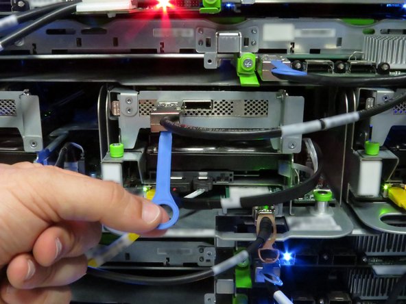 Disconnect the Mini-SAS cable by pulling on the pull-tab, as shown.