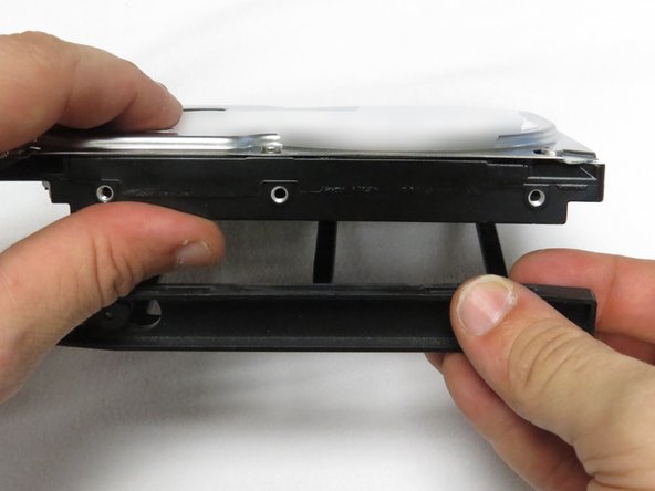 Install the new HDD into the drive caddy.