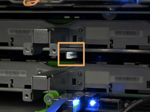 Align the outside edges of the SAS expander board with the nylon guides found underneath the storage tray chassis.