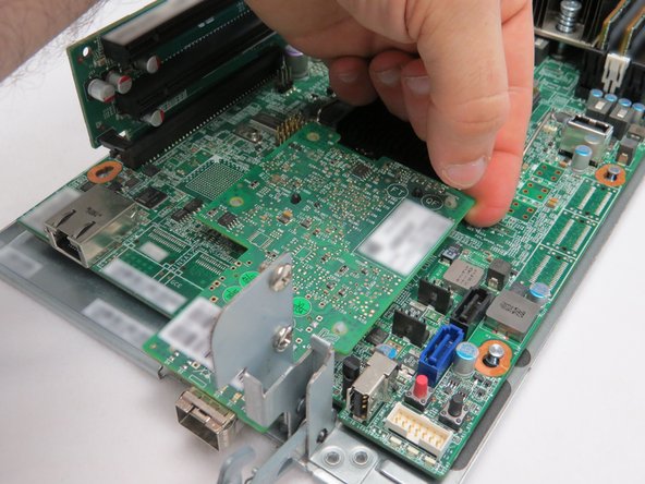 If the NIC cannot be pushed upwards, it may be necessary to use a tool (such as pliers) to pinch the arrowhead portion of the nylon standoffs.