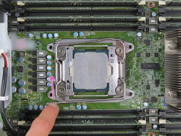 Unlatch the 'unlock' retention lock first, by simultaneously pushing down and inward on the lever as shown.