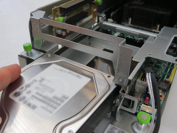 Push the HDD back into the riser cage assembly.