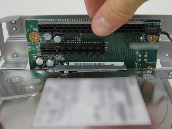 Slide the riser card downwards until it has seated on the studs.