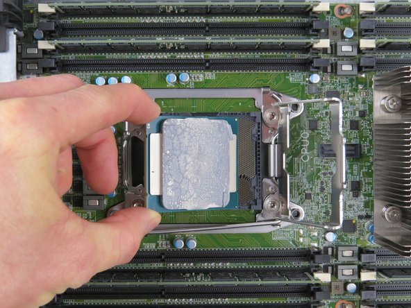 Grasp the CPU by its sides and remove.