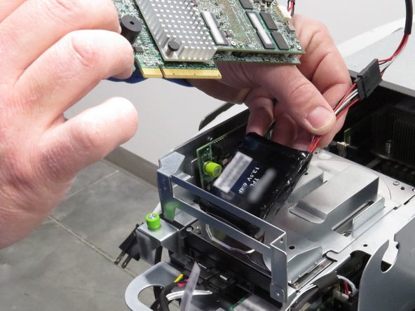 Remove the RAID controller and its tethered battery pack, as shown.