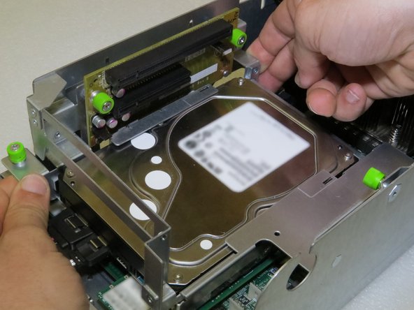 Grasp the left side of the riser cage, as shown.