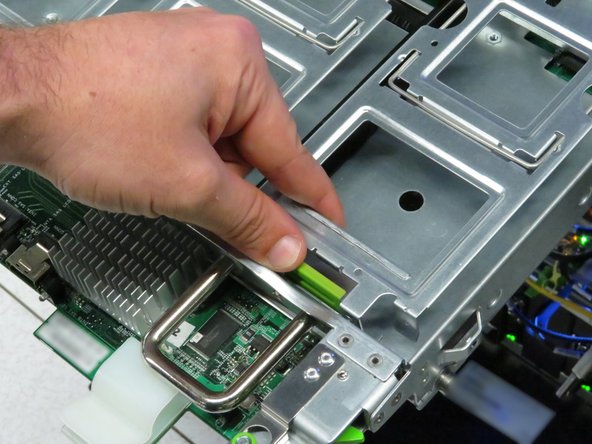 Press in the green tab on each drive gate.