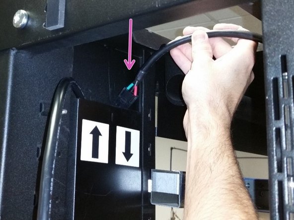 Insert the longer 3-pin DC power cable into the trough with the down arrow (for the lower power shelf).