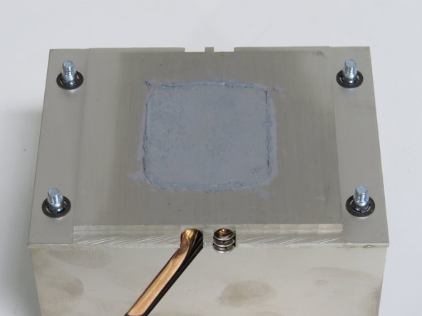 Scrape the thermal compound application from the heatsink using a plastic putty knife.