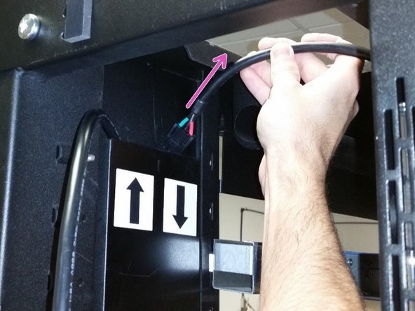 Unlatch the two green tabs on the PDU from the top of the rack and remove the PDU.