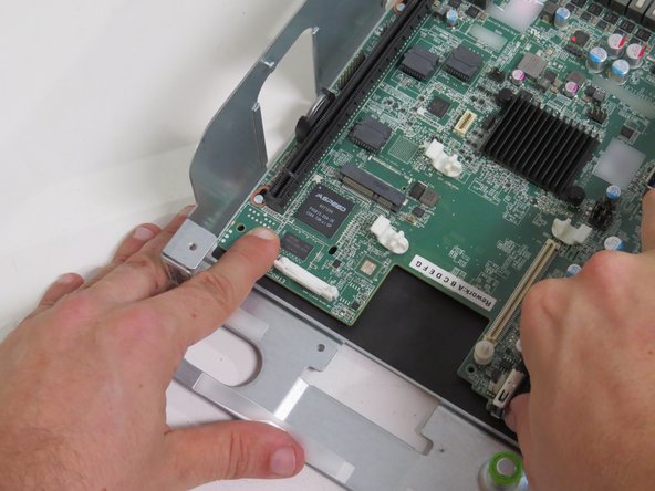 Push the motherboard towards the fans  until (7) motherboard standoffs clear the motherboard guides.