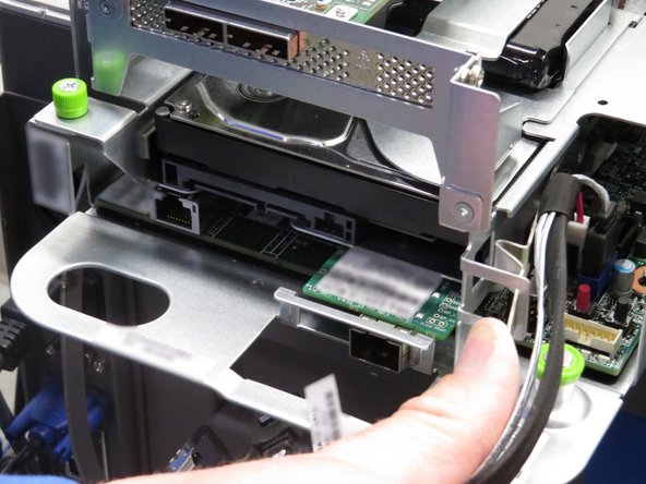 Push the HDD retention tab towards the right of the server node, as shown.