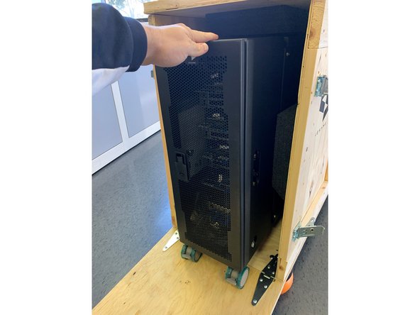 Grasp the top of the unit and wheel it down the open panel to the floor