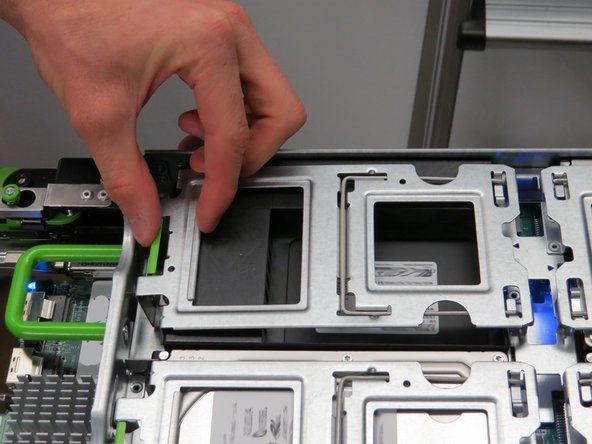 Lift the HDD locking gate by pressing the green tab, as shown.