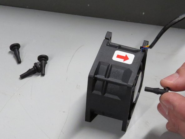 Insert grommets into the new fan.