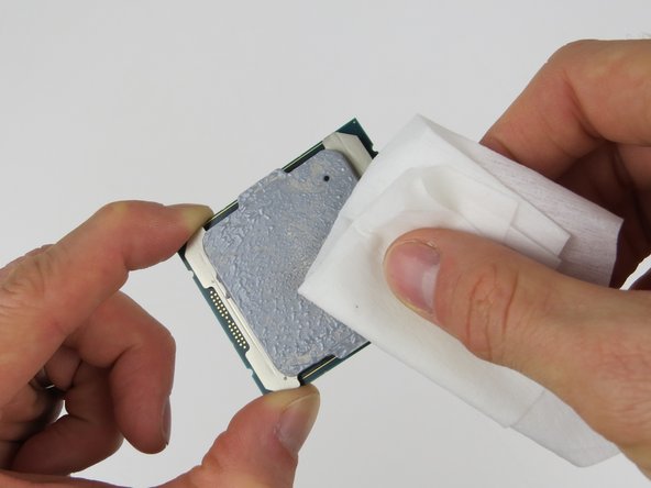 Wipe the top of the CPU with an ispropyl alcohol pad to remove the thermal compound residue.