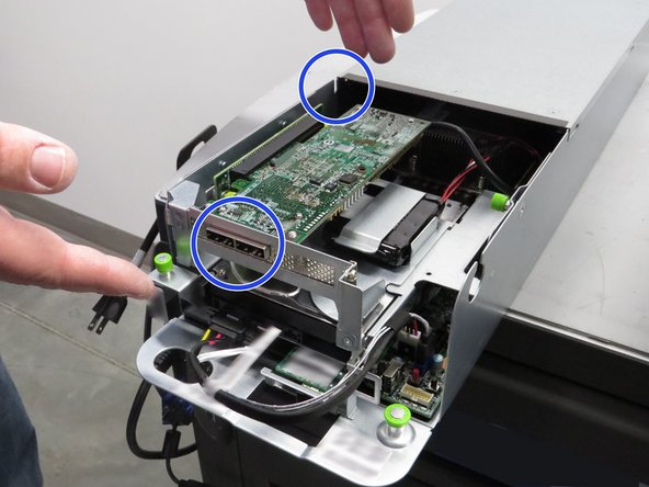 Grab the riser cage, as shown.