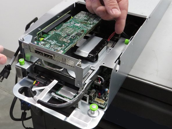 Unscrew the (2) thumbscrews until the cage releases.