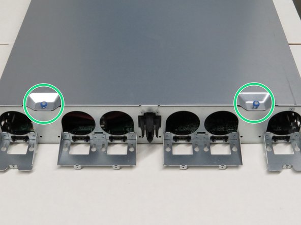 Loosen the two thumbscrews on top of the chassis lid.