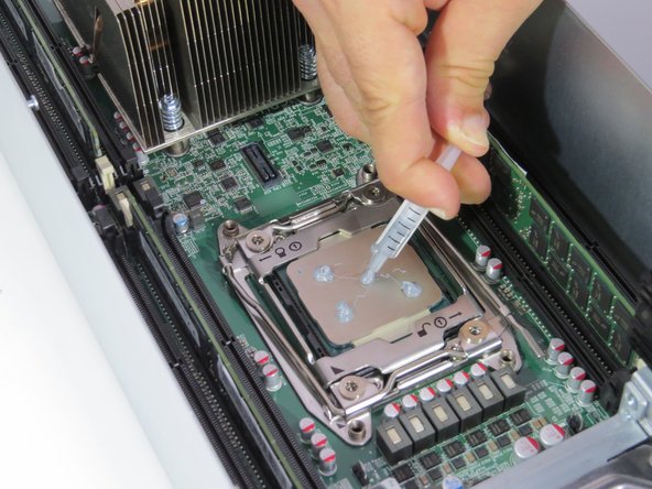 Place 0.2 grams of thermal compound on each CPU corner. Drag residue towards the center of the CPU.