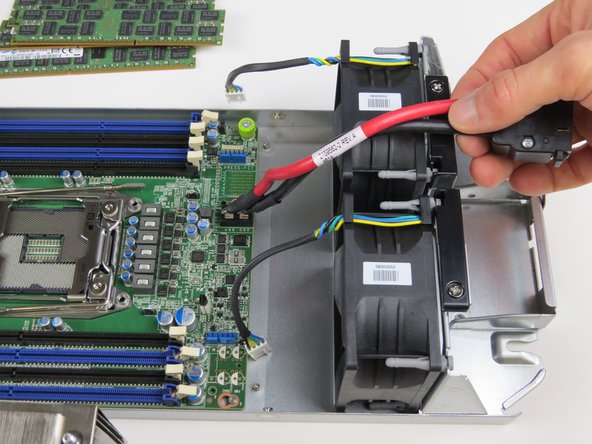 Carefully remove the motherboard power cable from in between the (2) fans as shown.