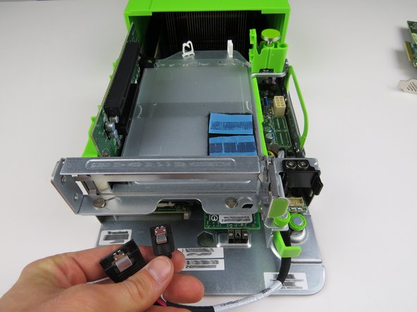 Disconnect the following cables by pressing down on the metal retention tabs pulling away from the HDD: