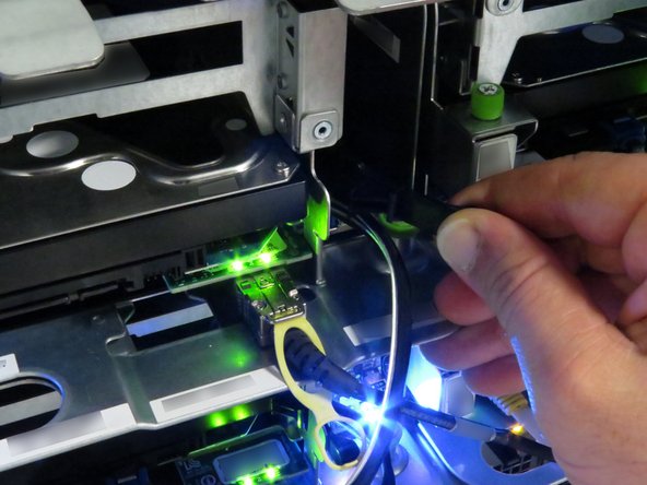 Pull the black nylon HDD release lever towards the front of the server.