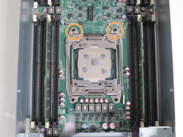 Align the rear (2) heatsink screw posts with the CPU retention post holes, as shown.