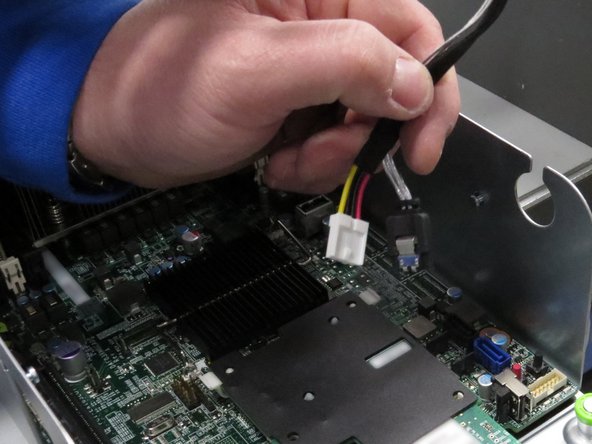 The SATA connector has a retention tab. It must be depressed to release the connector.