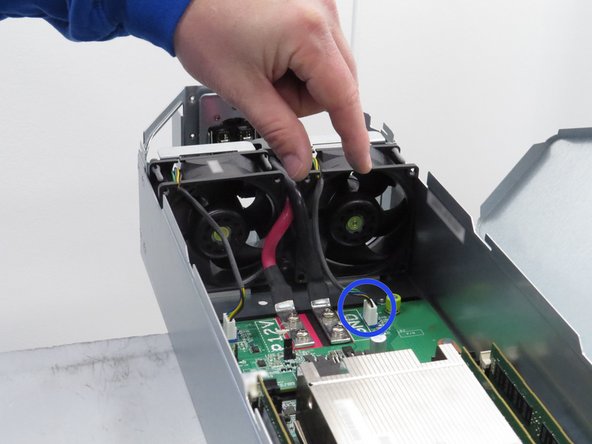 Grasp the fan power connector close to the connection header when disconnecting.